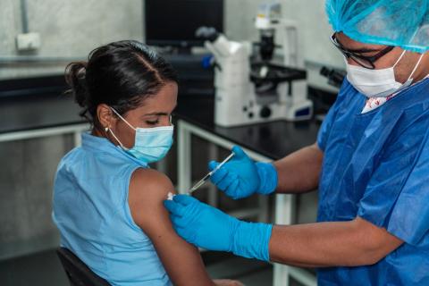 A woman receiving the COVID-19 vaccine